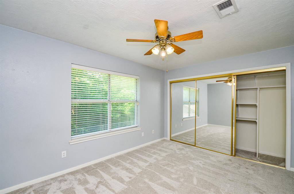 1st spacious secondary bedroom with wall to wall mirrored closet