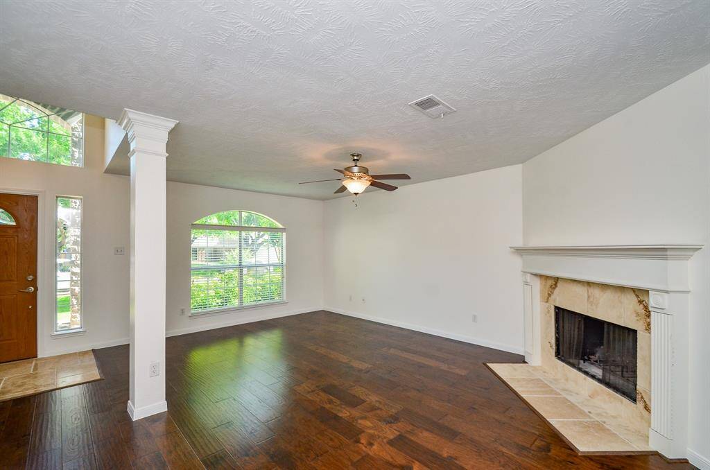 View of the living room with wood burning fireplace