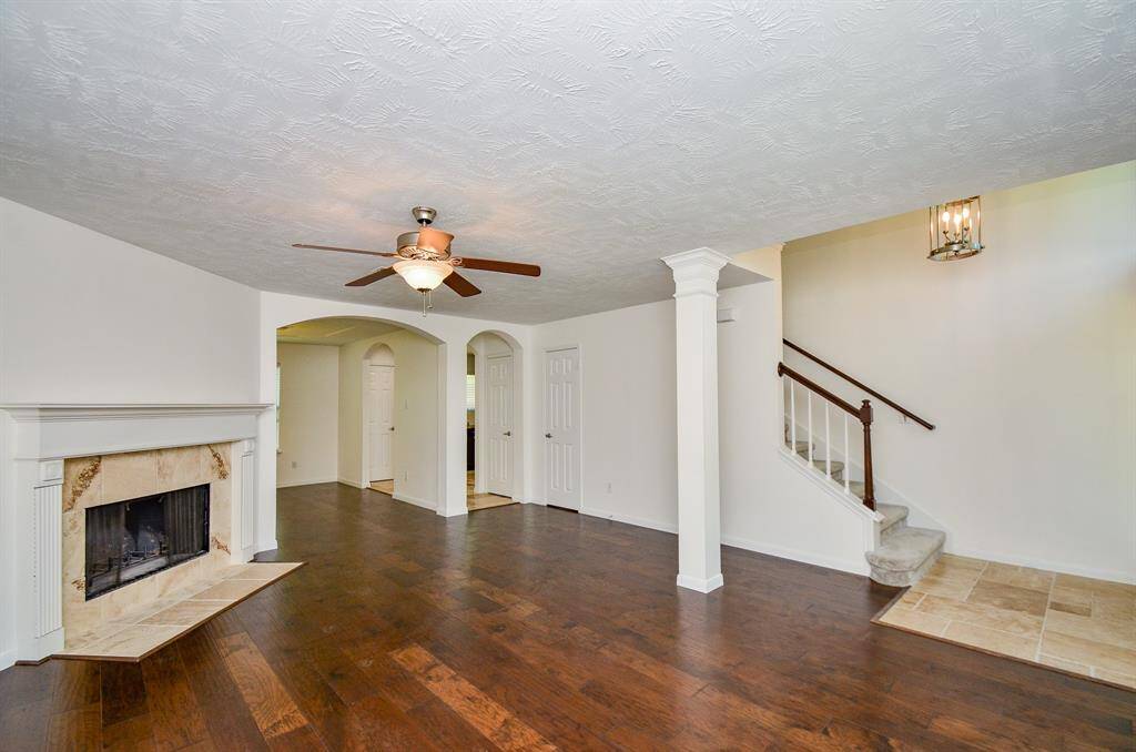 View of living room opening to formal dining room and kitchen.