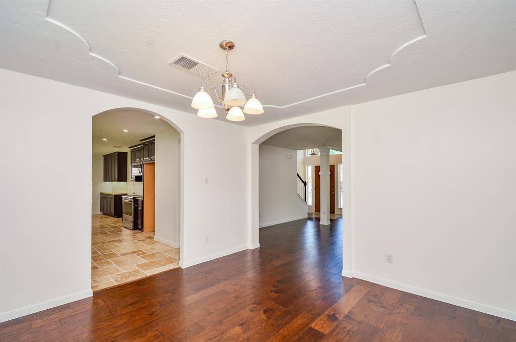 View of formal dining opening to kitchen and living room