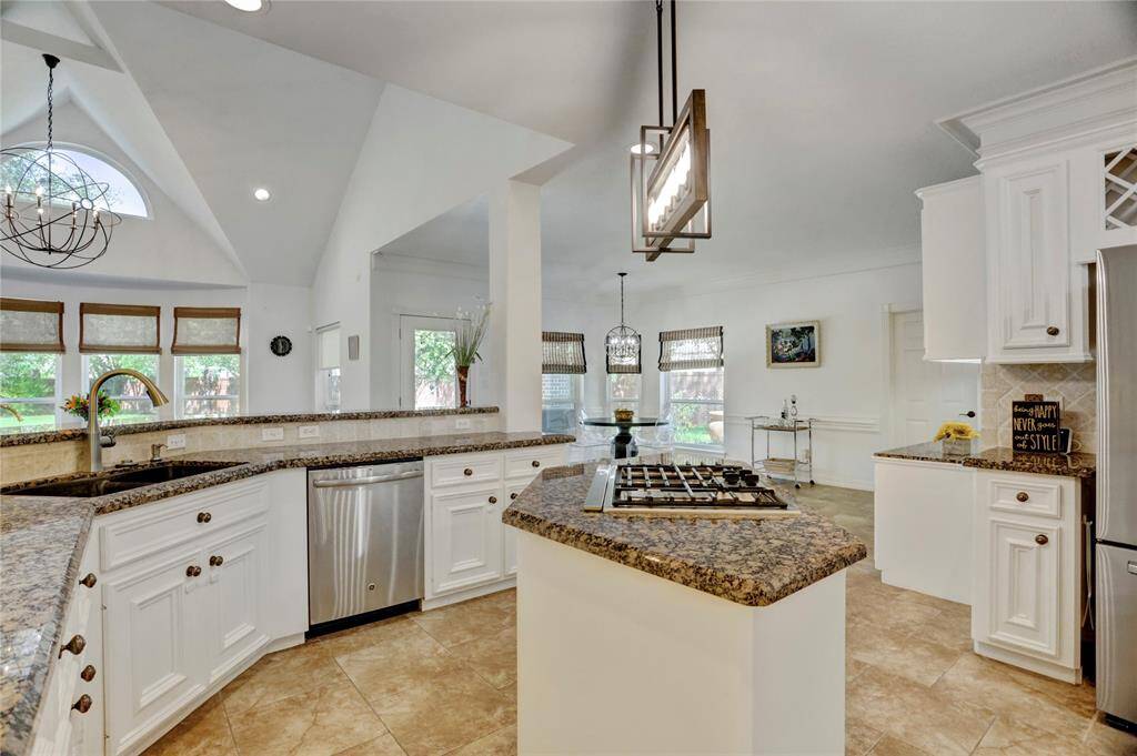 Spacious kitchen with abundant counter space, sleek stainless steel appliances, and a large, modern sink.