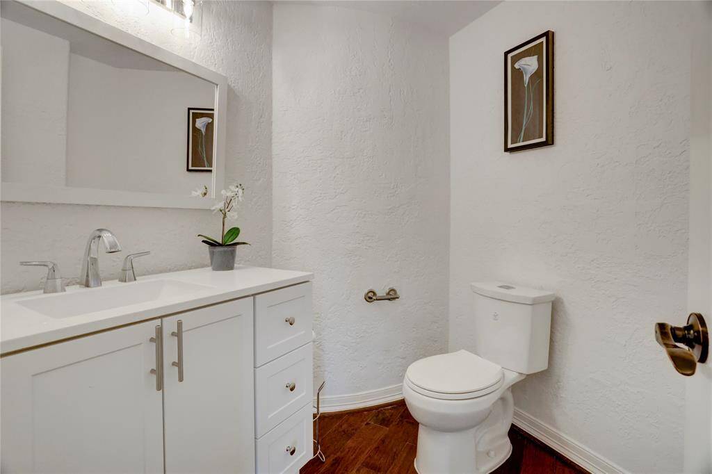 Elegant and functional powder room featuring modern fixtures and a sleek vanity, perfect for guests.