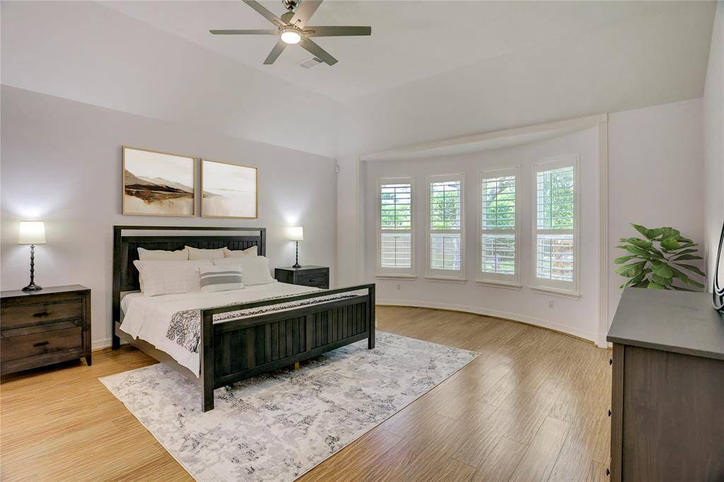 Expansive primary bedroom featuring a stunning bay window with four large panes for abundant natural light.