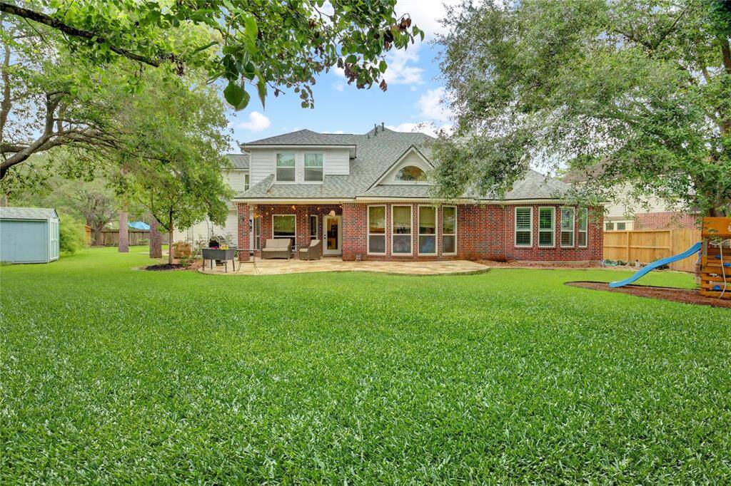 Enjoy the expansive backyard and impressive architecture of this spacious home.