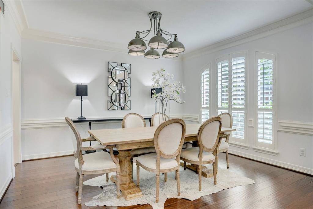 The dining room is open and spacious, ready for all your entertaining needs. Natural light pours in through the plantation shutters, enhancing the room's bright and welcoming atmosphere.