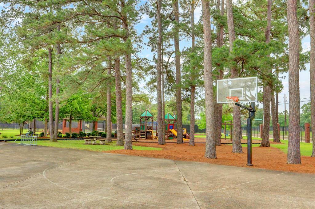 The Lakewood Oaks Estates recreation facilities also include spacious outdoor area with a basketball court and a playground set among tall trees. It's an ideal space for recreation and family activities.