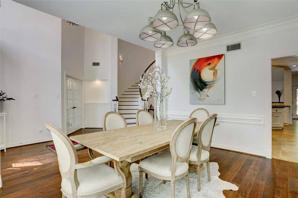 This view highlights the openness of the front foyer, and the doorway to the kitchen with the walk-in pantry directly behind the wall.