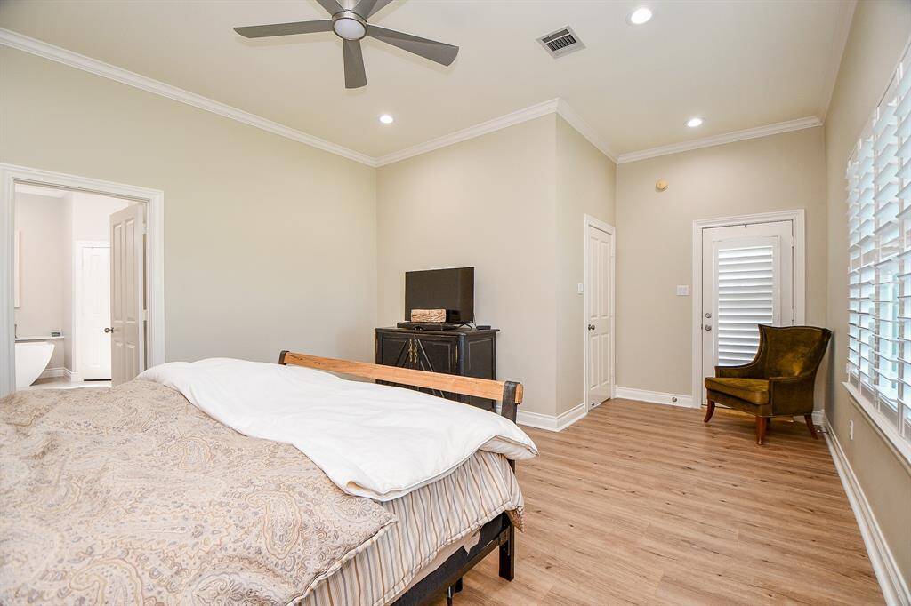 Another view of primary bedroom with sitting nook, door to outside and wall of windows to show off views!
