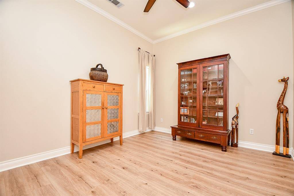 Lovely home office with cute little window to bricked atrium.