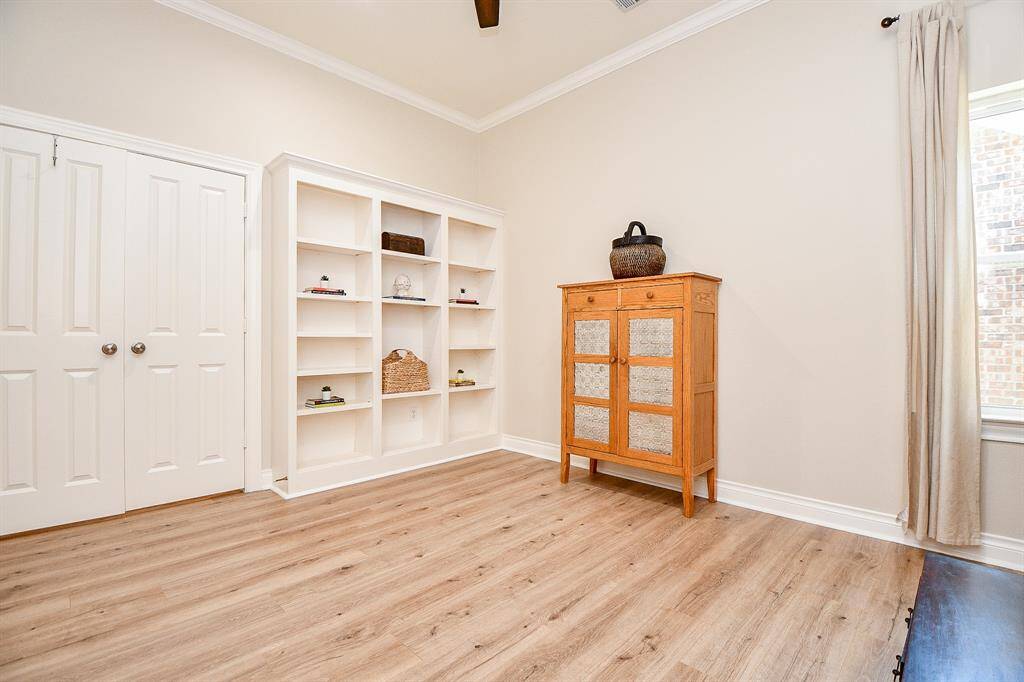 Another view of home office with double doors and built-in bookshelves.