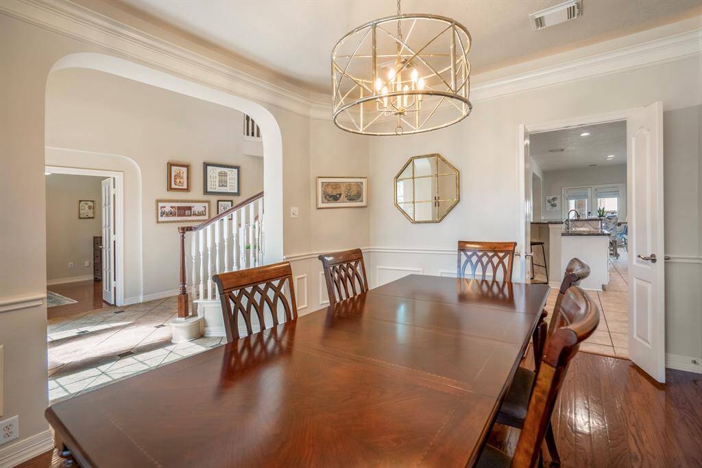 A highlight of this home is the architectural arches which elevate the home from the minute you walk in.  Double doors to the kitchen area are on the opposite end.