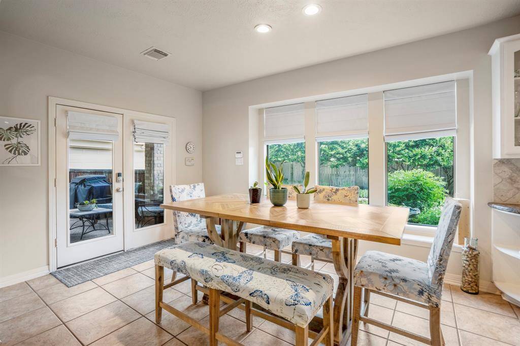 Double glass doors offer natural light and easy access to the covered backyard patio, also on offer are three large windows.