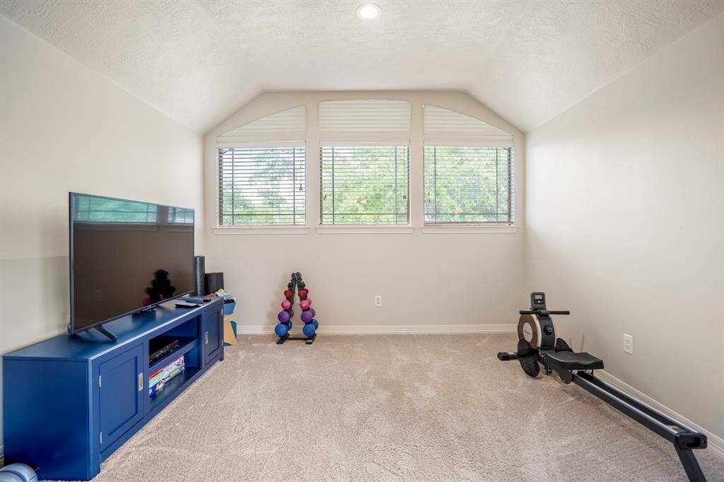 Slightly elevated is this flex space which this family are using as an exercise area.