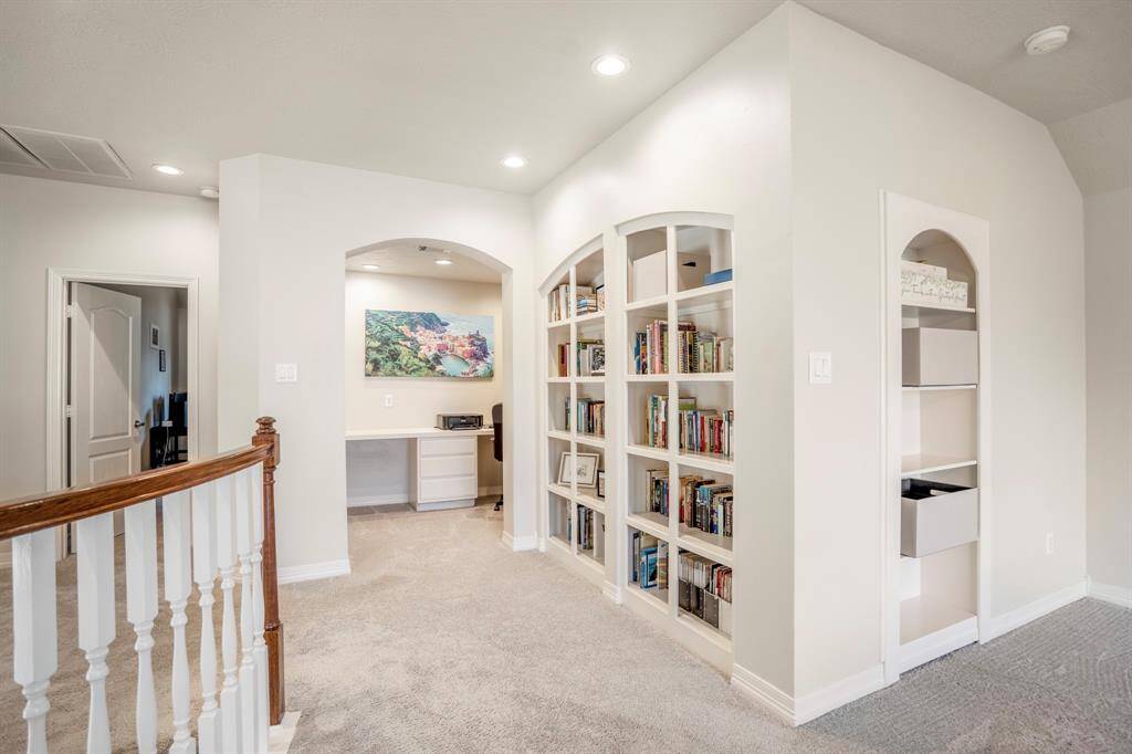 Just off the gameroom area there is a study nook, a wall of built-in bookshelves, and tons of storage for games, TV equipment or movies.