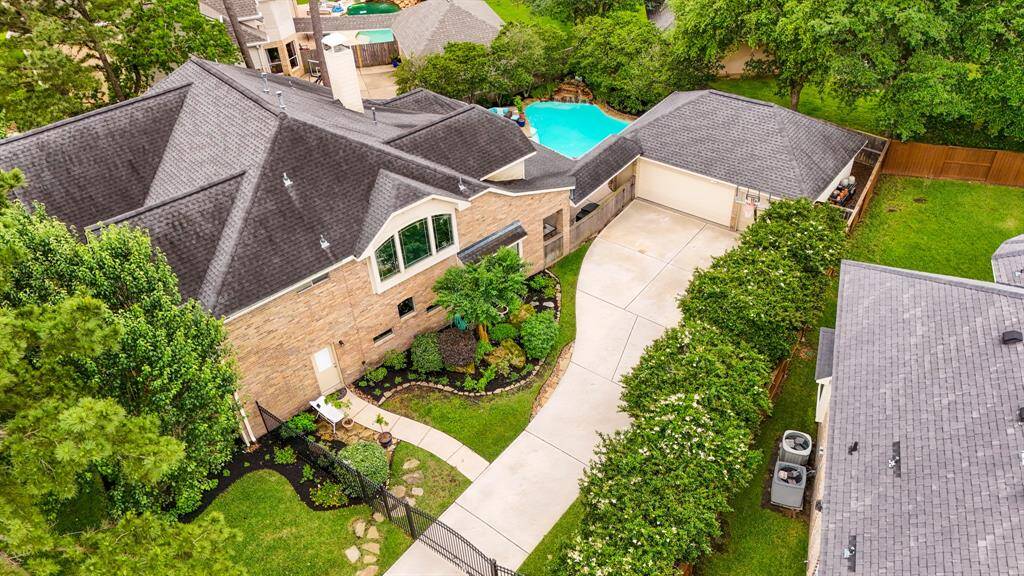 A side view of the home, which offers privacy and a wonderful place for children to play and ride bikes behind the safety of your own driveway gate.