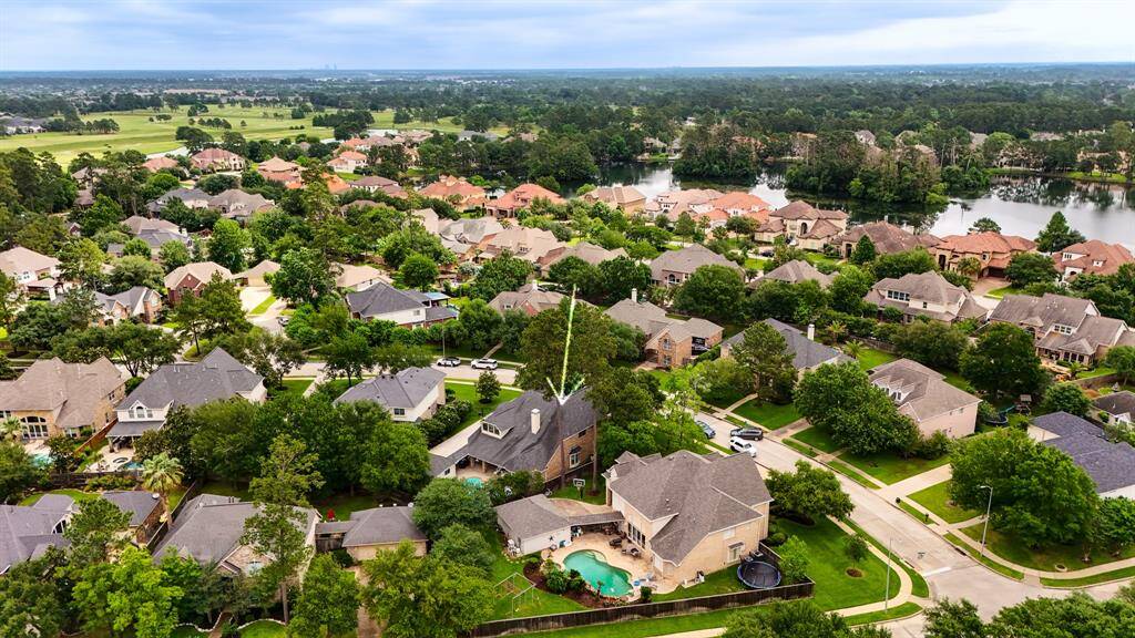 An aerial view of the home surrounded by other beautiful homes, within a short walk to the lake.  Enjoy bike and walking trails in your new neighborhood.