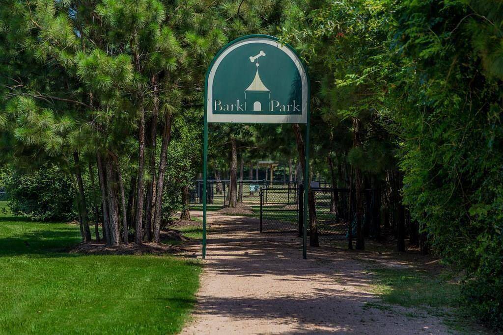 The BARK PARK where our 4-legged family members enjoy a 2.5-acre fenced dog park featuring separate areas for small & large dogs, trails, drinking fountains for pets and shaded seating for their owners.