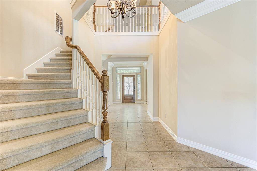 Staircase leading to 4 bedrooms, upstairs, and large game room.