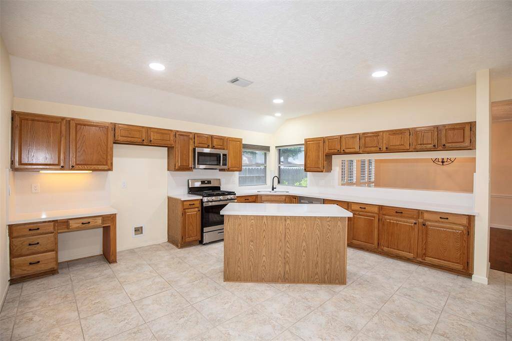 This spacious kitchen offers both style and functionality, featuring a large island with additional storage space—perfect for meal prep or casual dining.