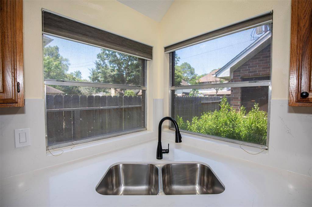 The kitchen sink is thoughtfully positioned under a window, offering a pleasant view outside and plenty of natural light.