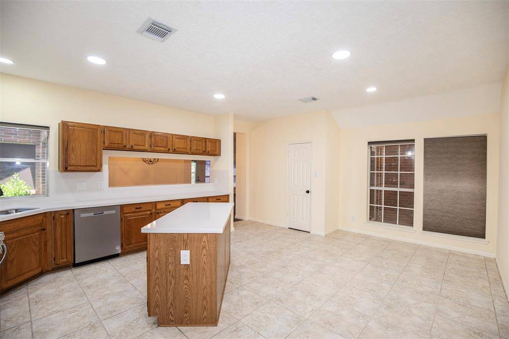 A view of the kitchen looking to the breakfast area and pantry.