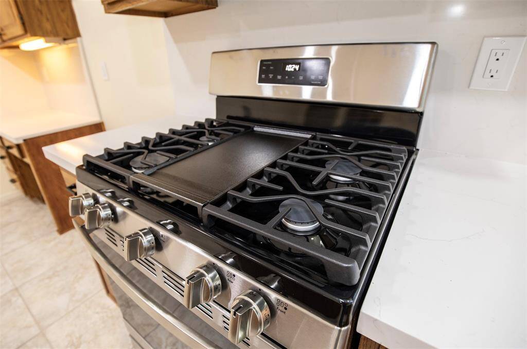 This gourmet gas stove, recently installed, is sure to please any cook.