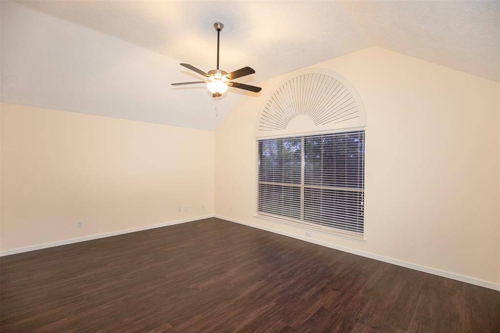 Huge primary bedroom with enough space for king size furniture.