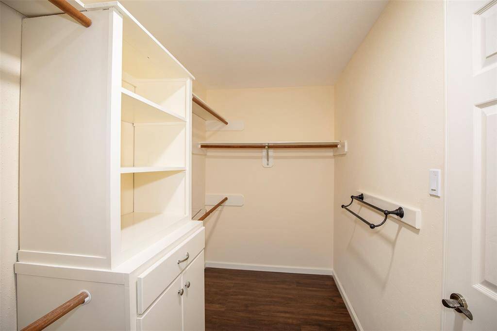The primary suite has a large, walk-in closet with built-ins.