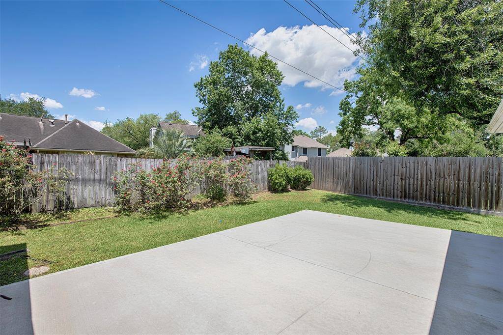 Another view of the marvelous backyard with lush landscaping that runs along the back fence.