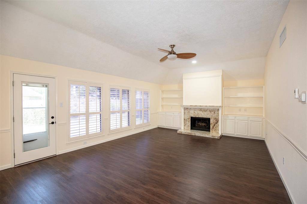 This inviting family room features beautiful luxury plank flooring that adds warmth and elegance to the space.