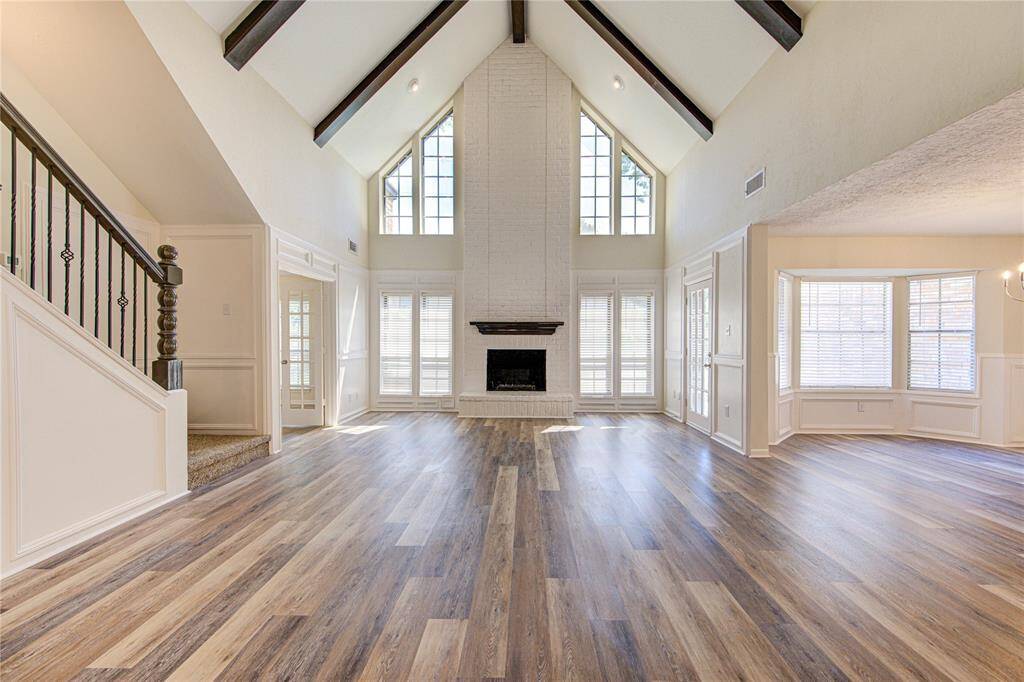 The family room has a wonderful floor-to-ceiling fireplace and wood beams at the ceiling.