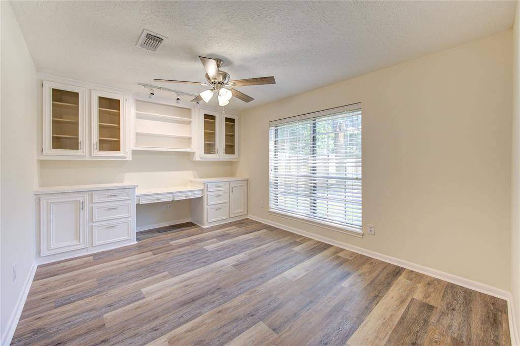 There is a home office off of the family room with double French doors.  The home office has a built in desk and storage.  The new flooring continue in here too.