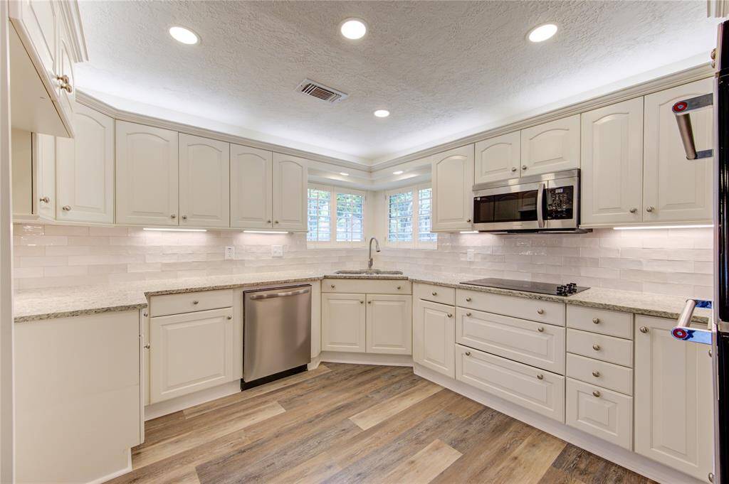 The kitchen has newer cabinets, new granite, backsplash, sink, faucet, and appliances.  There is also overhead and undermount cabinet accent lighting as well as new LED main lighting.