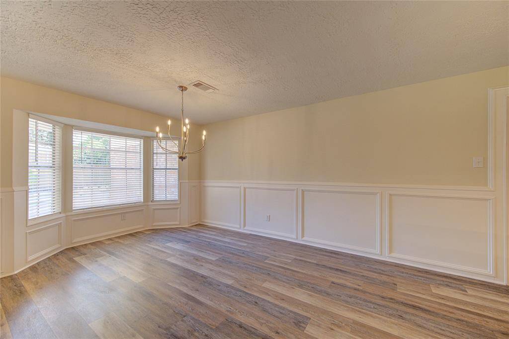 Large breakfast room with bay window and new chandelier.