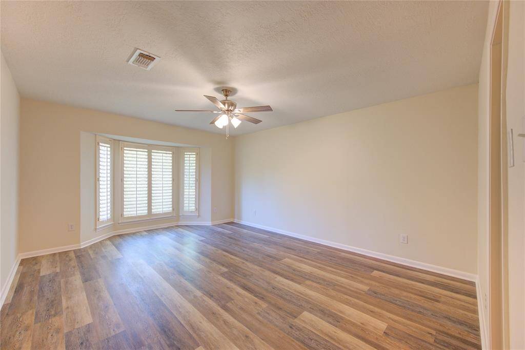 Primary bedroom is downstairs and has plantation shutters and all new flooring.  All bedrooms have ceiling fans.
