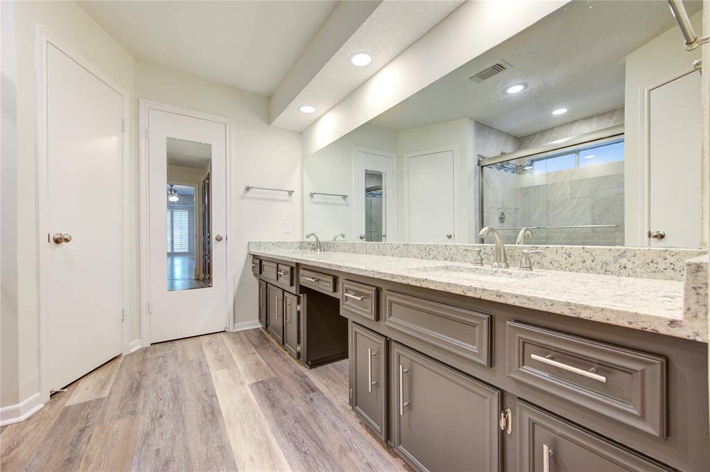 Primary bath with new granite and undermount sinks and stylish new cabinet pulls.