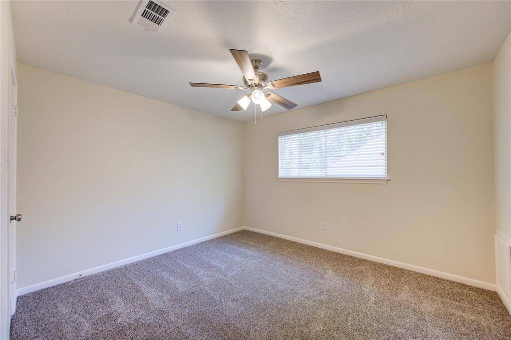 Bedroom 3.  All bedrooms have walk in closets and ceiling fans.  All bedrooms have window coverings.  The entire upstairs has all new carpet and padding.