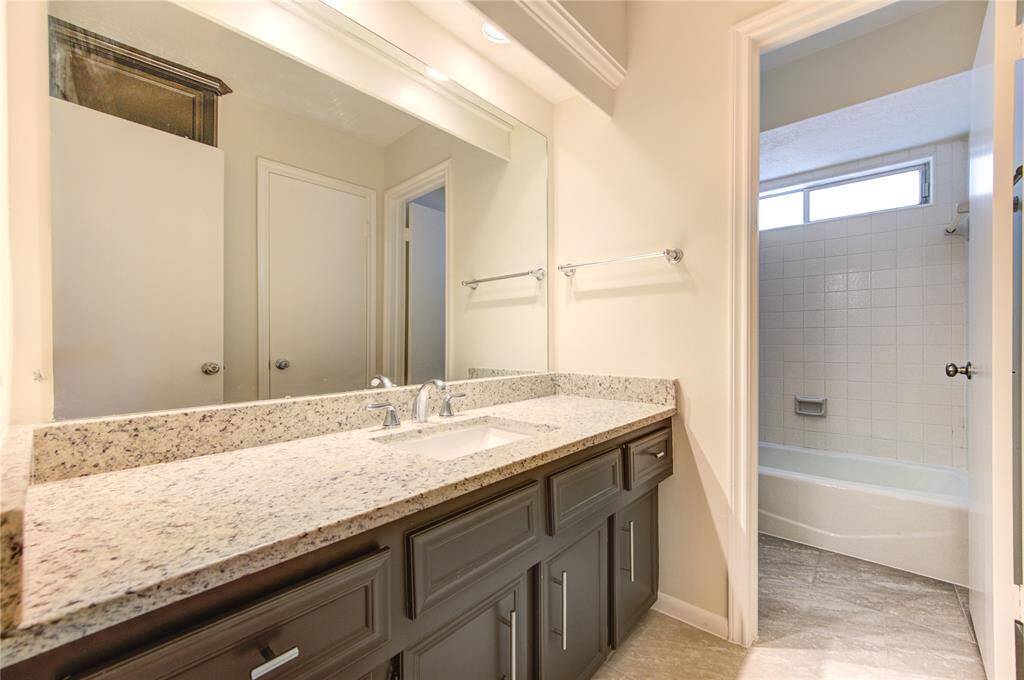 Bathroom 2 has new granite and sink, and new tile flooring and cabinet pulls.  This home has 3 full baths and a half-bath.