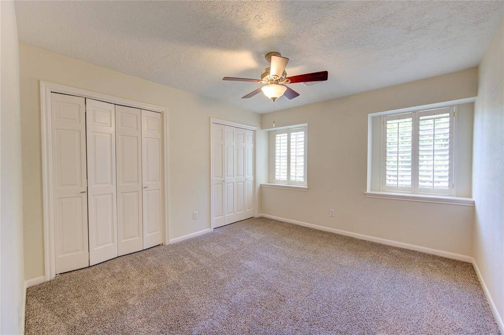 Bedroom 4.  All bedrooms have walk in closets and ceiling fans.  All bedrooms have window coverings.  Those at the front of the house have plantation shutters. The entire upstairs has all new carpet and padding.