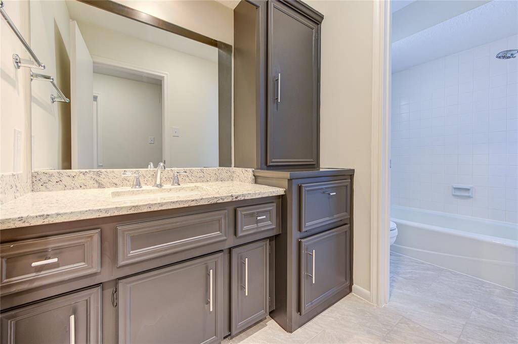 Bathroom 3 has new granite and sink, and new tile flooring and cabinet pulls.  This home has 3 full baths and a half-bath.