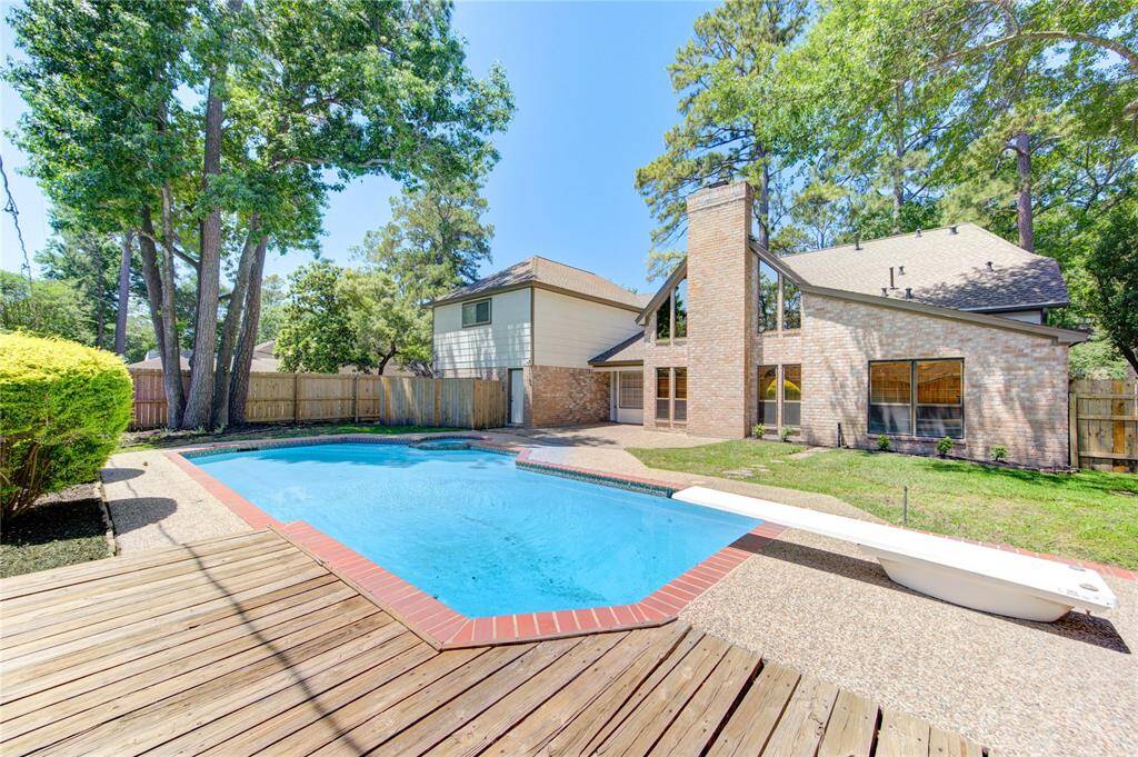 There is a wood deck at the back side of the pool