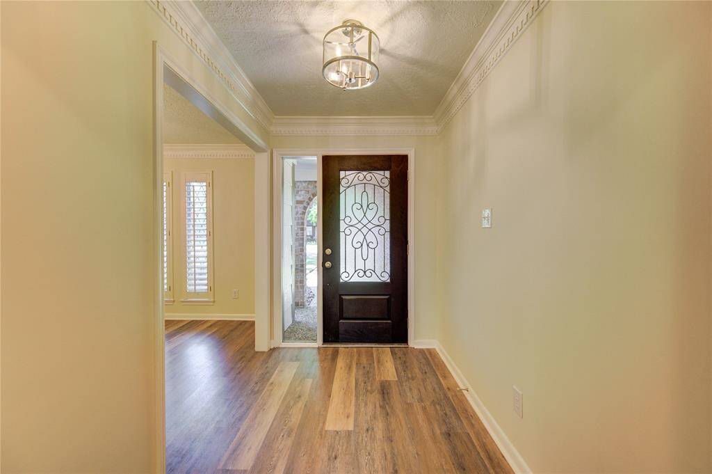Home has been tastefully updated with new fixtures, all new flooring, and fresh paint. This is the foyer and it has a new entry door.