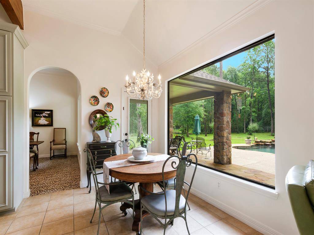 This bright and cheerful breakfast room features a high tray ceiling and large picture window that fills the space with natural light creating an inviting a peaceful spot to start the day.