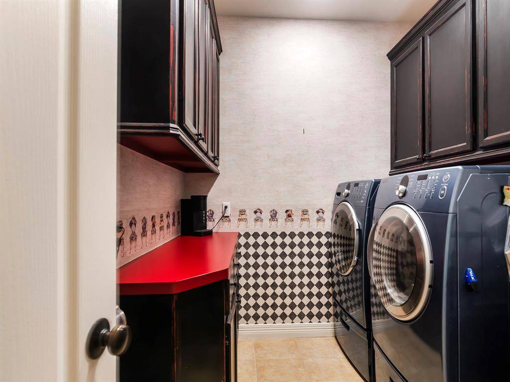 The utility room features upper & lower cabinets with a built-in countertop, offering plenty of storage and workspace for everyday tasks.
