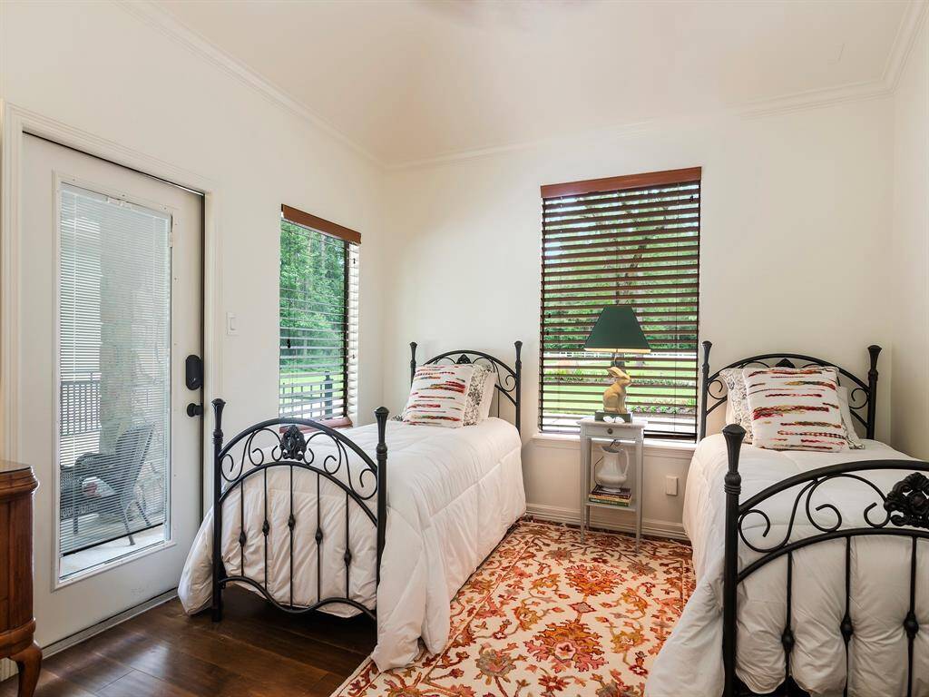 This charming secondary bedroom features wood floors, two large windows that fill the space with natural light, an ensuite bath and a spacious closet for added convenience. Also has its own private exterior door entrance.