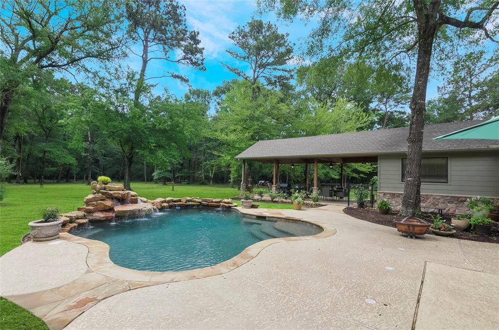 Relax in your private heated swimming pool, complete with a tranquil waterfall and brand-new Polaris cleaner, all set against a serene backdrop. surrounded by five peaceful acres, the setting feels like a secluded resort-perfect for quiet mornings or lively gatherings with family & friends.