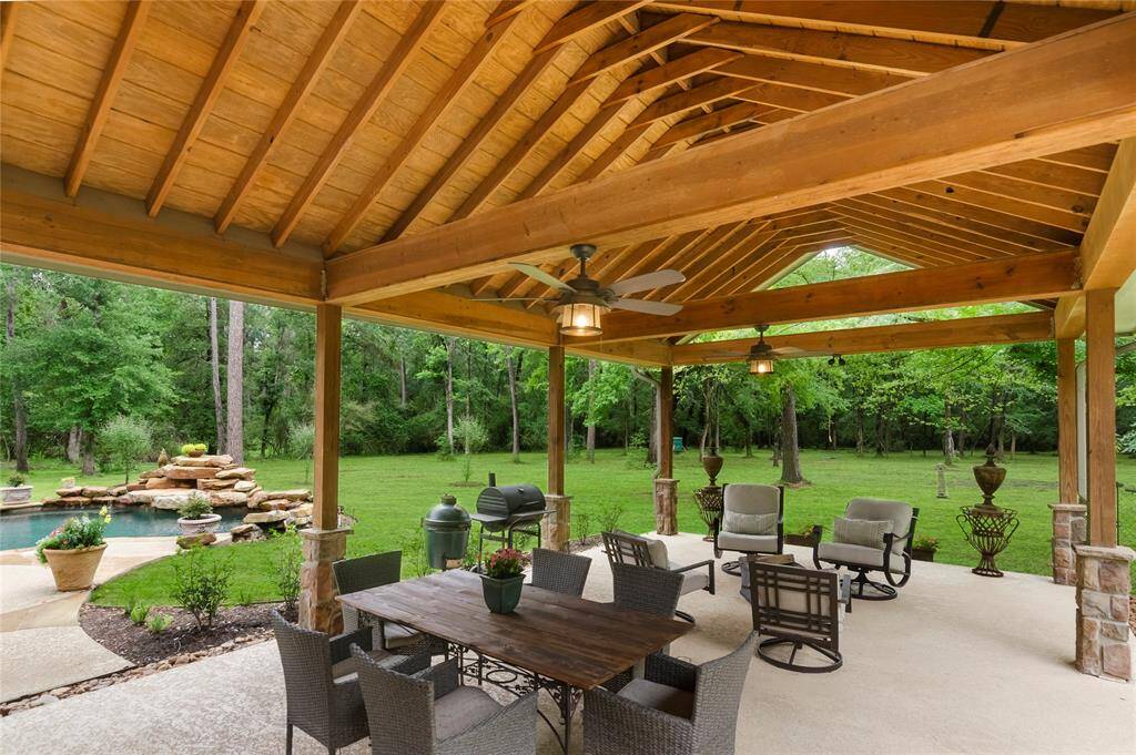 This expansive 31'x17' wood pavilion with a tray ceiling offers the perfect outdoor space to dine, relax, share conversation-or slow-smoke a rack of ribs in comfort & style.