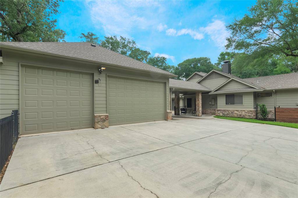 Two-car attached garage alongside the spacious detached workshop which includes a three-car garage, offering ample space for vehicles, projects and storage.