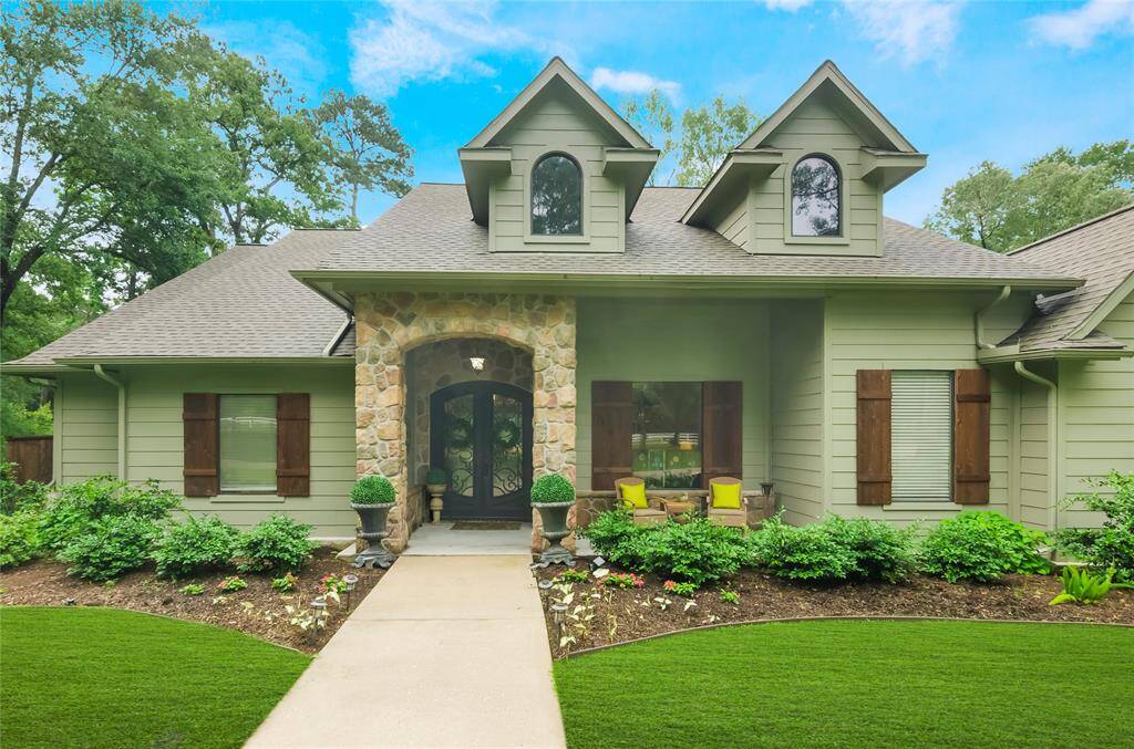 An inviting front entrance welcomes you with a cozy sitting porch, wooden shutters and warm architectural details that create instant curb appeal.