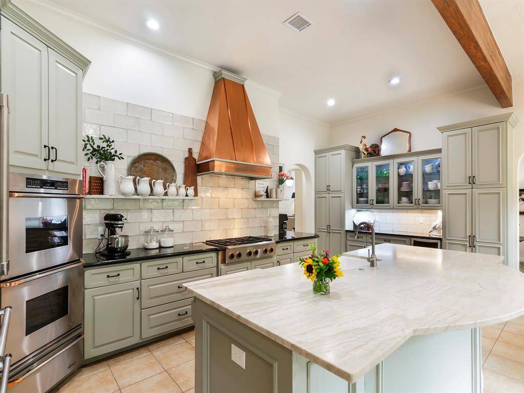 You will appreciate the luxurious leathered quartzite countertop that anchors the kitchen island. It's stunning, durable and irresistibly smooth to the touch.